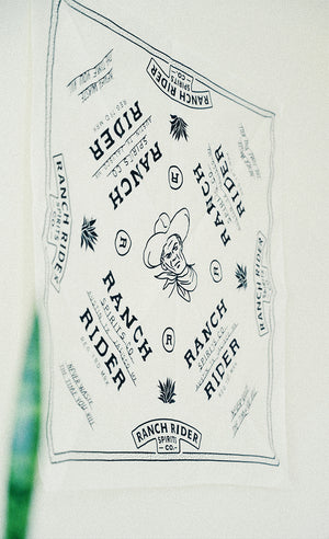 Blue and white bandana with western motifs and the Ranch Rider logo.