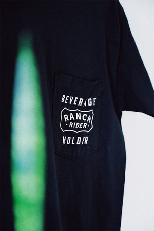 Dark blue t-shit with text in white that says “Beverage Holder” with the Ranch Rider logo on the pocket.