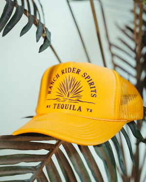 Yellow baseball cap with "Ranch Rider Spirits Tequila" and an agave plant.