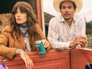 Image of a man and woman in western wear, hanging their arms over the back of a red pickup truck. The woman has long brown har with curls and holds a can of the Original Ranch Water with teal labeling. The man is wearing a cowboy hat and holding a can of the Tequila Paloma pre-made cocktail with peach labeling.