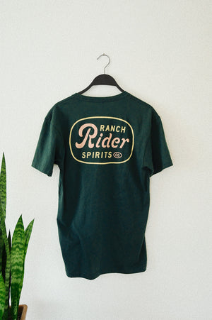 Dark green t-shirt with a pink and yellow design on the back that says “Ranch Rider Spirits.”