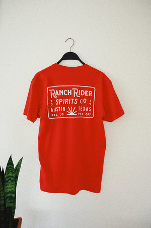 Red t-shirt with white Ranch Rider design on the back.